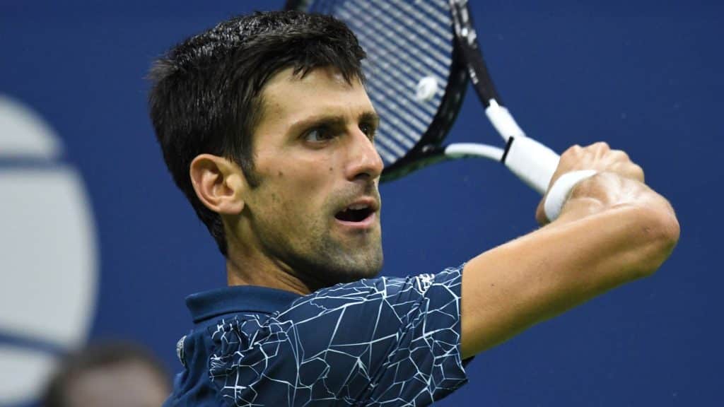 Tennis player using his racket